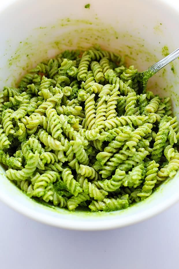 this Healthy Pesto Pasta is Vegan and Gluten Free! healthy and super simple to make! topped with sauteed tomatoes and onions!