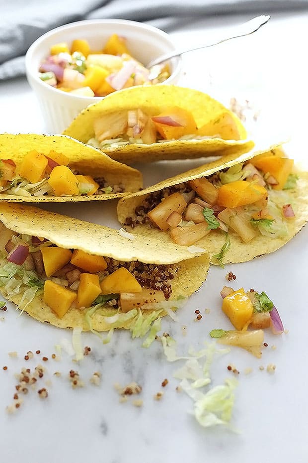 Vegan Caribbean Quinoa Tacos! Nutty quinoa meets fresh and spicy chili pineapple mango salsa in these tacos! These tacos are super quick and easy to make. Vegan and Gluten Free! / TwoRaspberries.com