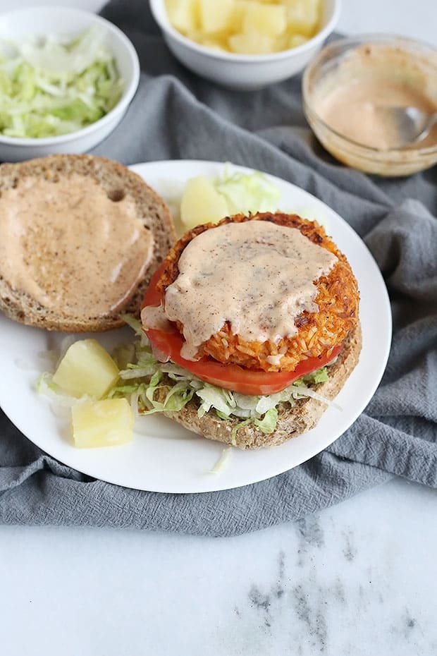 These Vegan Chili Pineapple Sweet Potato Burgers are FULL of flavor! sweet pineapple and spicy chili make an amazing combo. A chili flavored spread pairs perfectly with these burgers! Vegan and Gluten Free Option. / TwoRaspberries.com