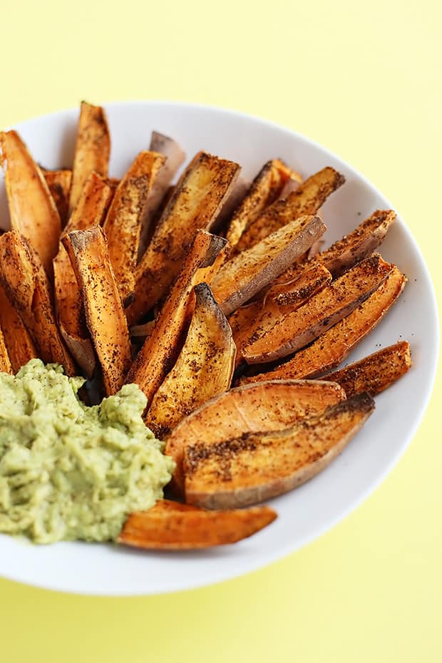 These Chili Lime Baked Sweet Potato Wedges are SUPER easy to make and the avocado lime dip is the perfect pairing for these wedges! Vegan and gluten free. / TwoRaspberries.com