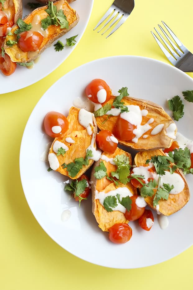 These Healthy Baked Sweet Potatoes with Lime Tahini Sauce are the perfect comforting dinner! Two sauce options included! Vegan and Gluten Free. / TwoRaspberries.com