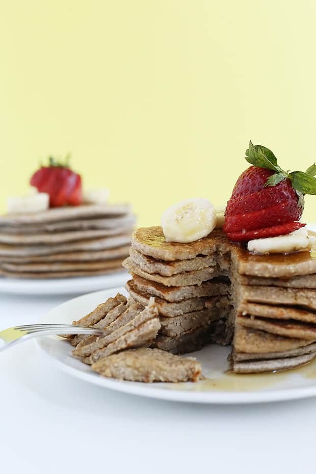 Strawberry Banana Oat Pancakes are full of fiber from the oat’s healthy and easy to make! They are naturally sweetened, vegan and gluten free./ TwoRaspberries.com