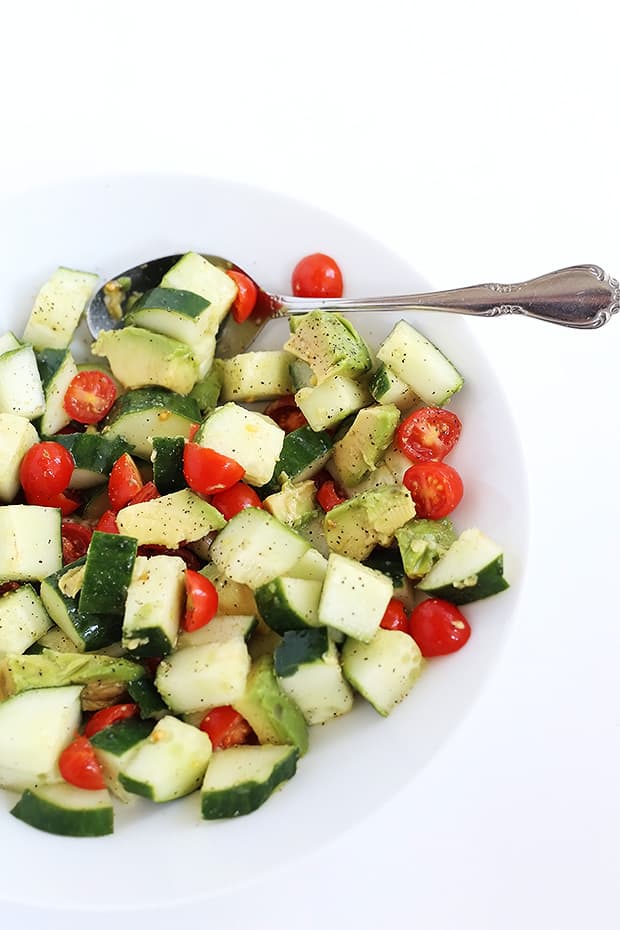  This Healthy Tomato Avocado Cucumber Salad is quick and easy to prepare, healthy, and has two different dressing options, smoky or sweet. Vegan. / TwoRaspberries.com
