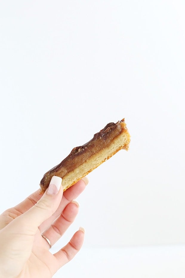 Homemade Vegan Almond Butter Twix with a twist on the bottom cookie layer! Super easy to make, only 6 ingredients, vegan, gluten free and refined sugar free photo / TwoRaspberries.com
