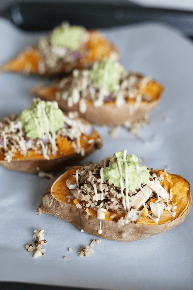These Healthy Quinoa Stuffed Sweet Potatoes are oil free, vegan and gluten free topped with avocado and a sweet tahini sauce. | TwoRaspberries.com