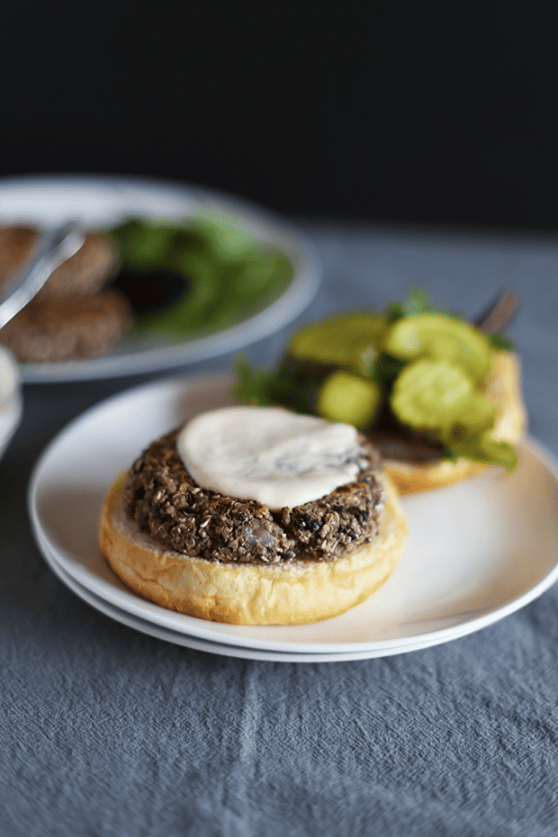 These 5 Ingredient Garlic Onion Black Bean Burgers are SO easy to make, paired with a tahini lime sauce, healthy, VEGAN and GF! | TwoRaspberries.com