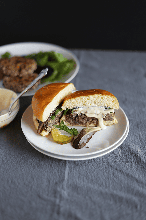 These 5 Ingredient Garlic Onion Black Bean Burgers are SO easy to make, paired with a tahini lime sauce, healthy, VEGAN and GF! | TwoRaspberries.com