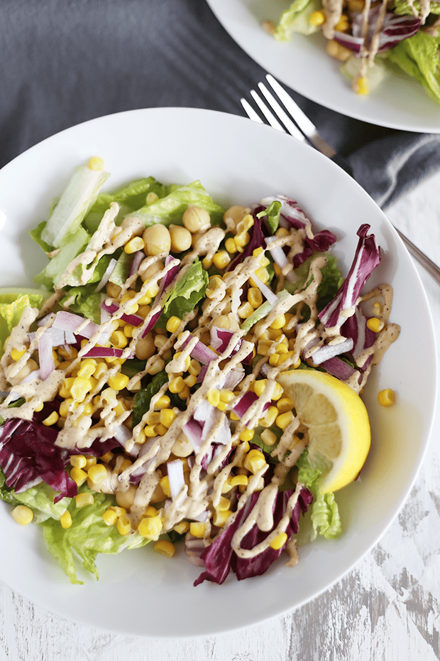 This Easy Clean Chickpea Corn Salad is healthy, quick and easy to make, packed with protein and healthy fats, paired with a chili tahini dressing! Vegan, GF | TwoRaspberries.com