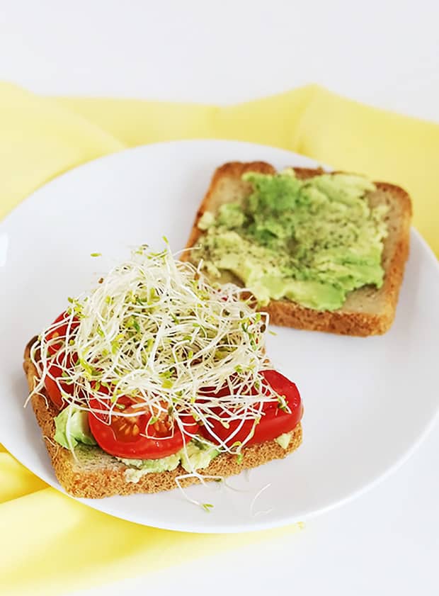 My Favorite Easy Avocado Tomato Sandwich! Avocado and tomato make such a wonderful combo the sprouts add many vitamins, minerals and enzymes! Vegan and GF / TwoRaspberries.com