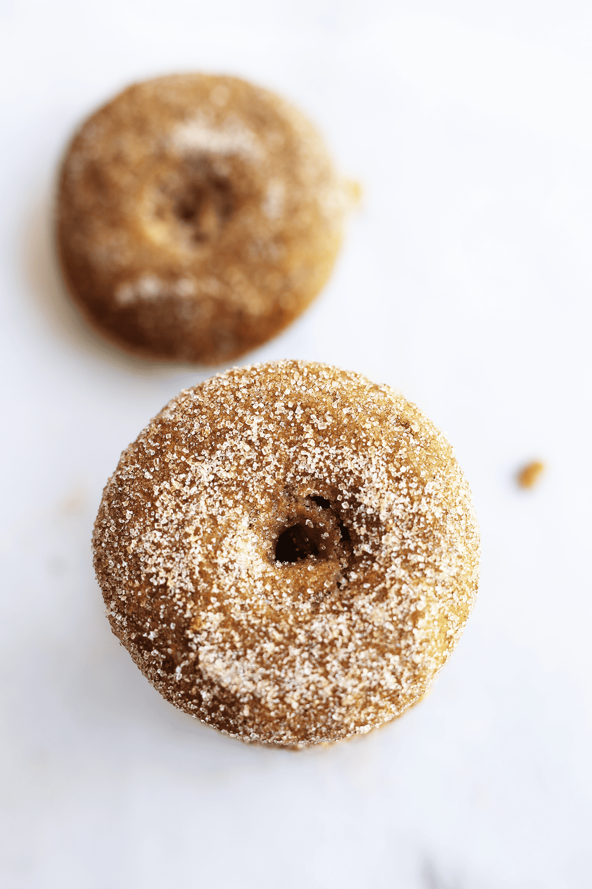 These homemade baked Apple Cider Donuts are vegan and sure easy plus delicious! They are coated in cinnamon sugar and sure to make the house smell amazing.