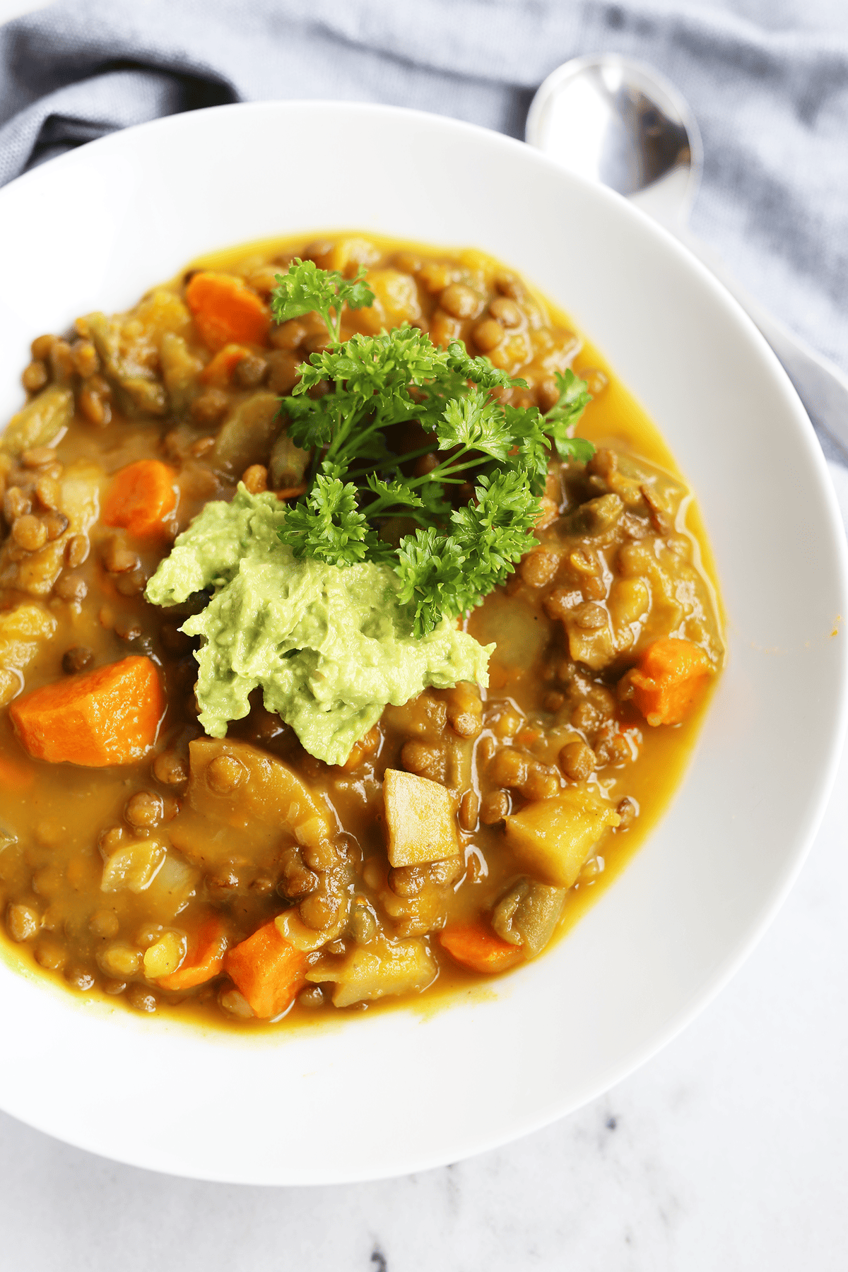 This homemade Pumpkin Lentil Soup is easy and super hearty packed with carrots, potatoes and full of fresh flavors! Vegan and gluten free.
