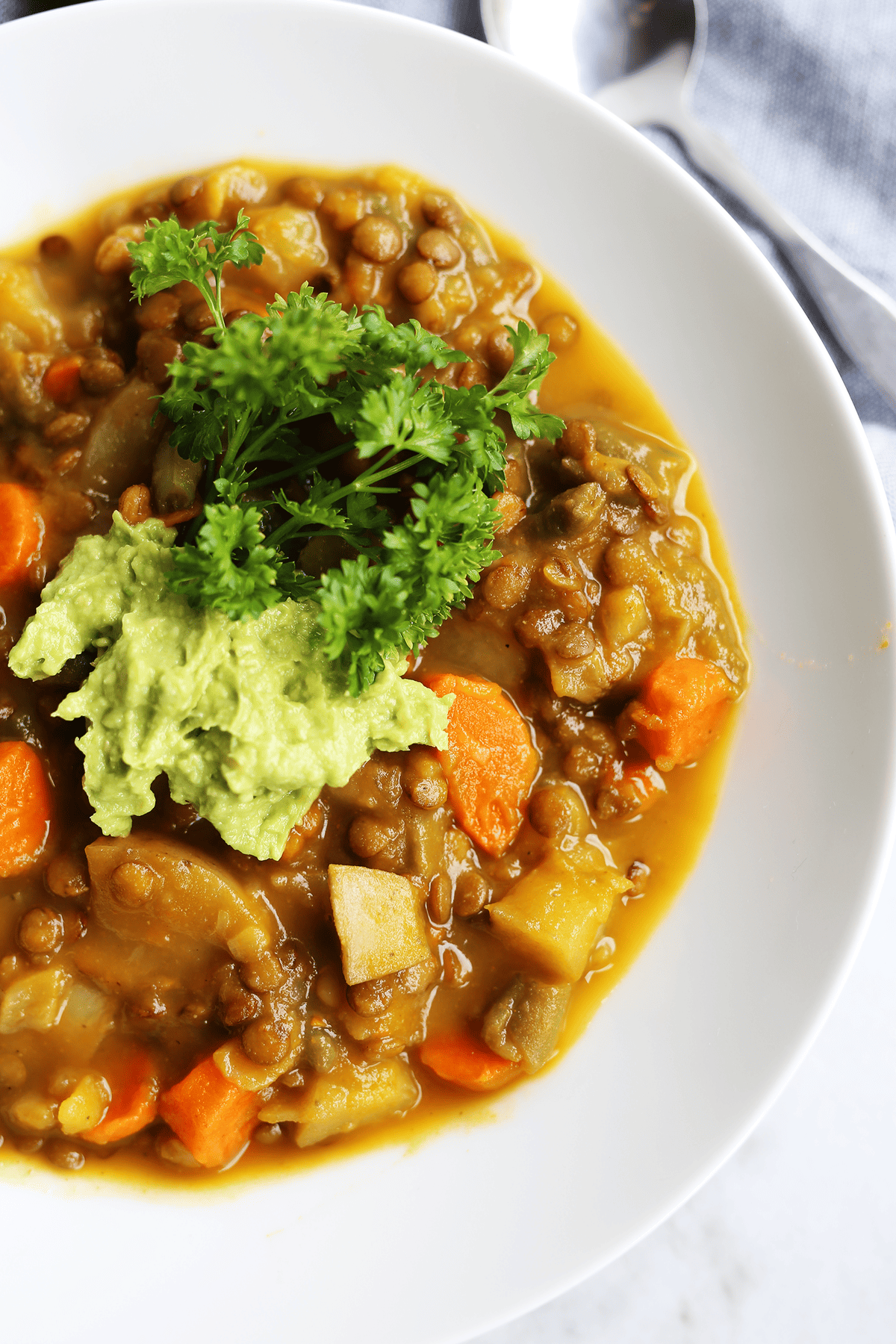 This homemade Pumpkin Lentil Soup is easy and super hearty packed with carrots, potatoes and full of fresh flavors! Vegan and gluten free.