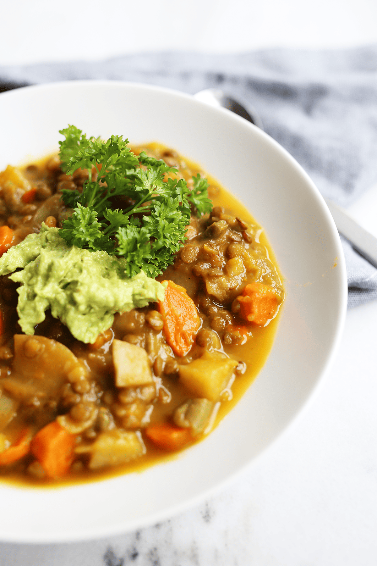 This homemade Pumpkin Lentil Soup is easy and super hearty packed with carrots, potatoes and full of fresh flavors! Vegan and gluten free.