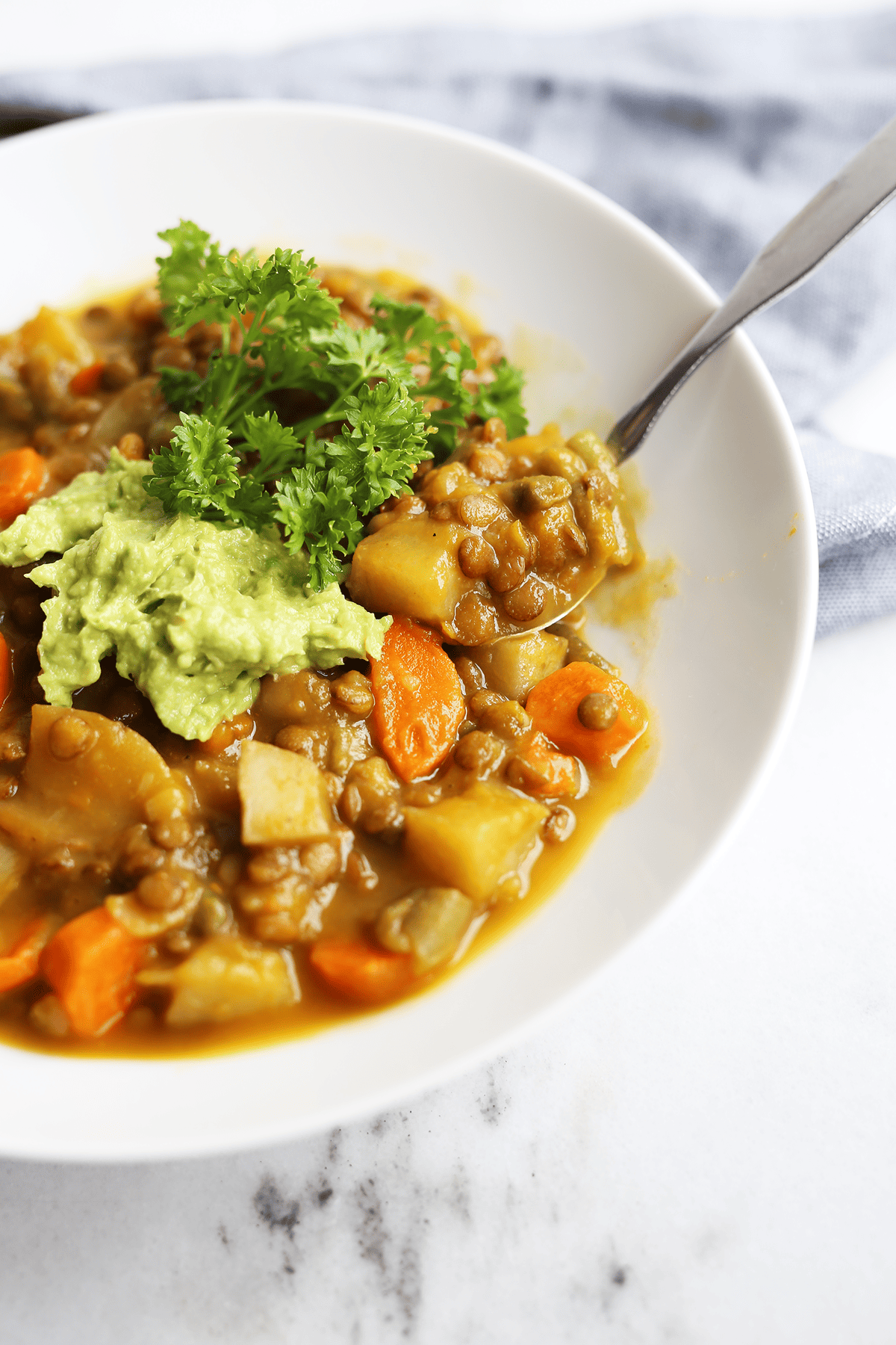 This homemade Pumpkin Lentil Soup is easy and super hearty packed with carrots, potatoes and full of fresh flavors! Vegan and gluten free.