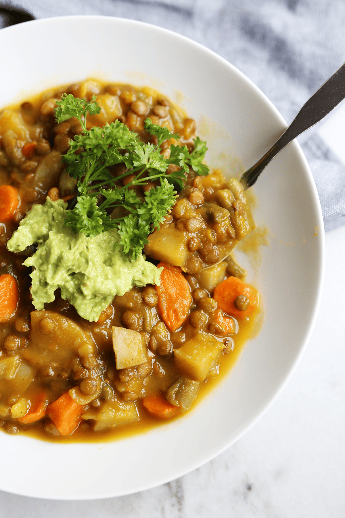 This homemade Pumpkin Lentil Soup is easy and super hearty packed with carrots, potatoes and full of fresh flavors! Vegan and gluten free.