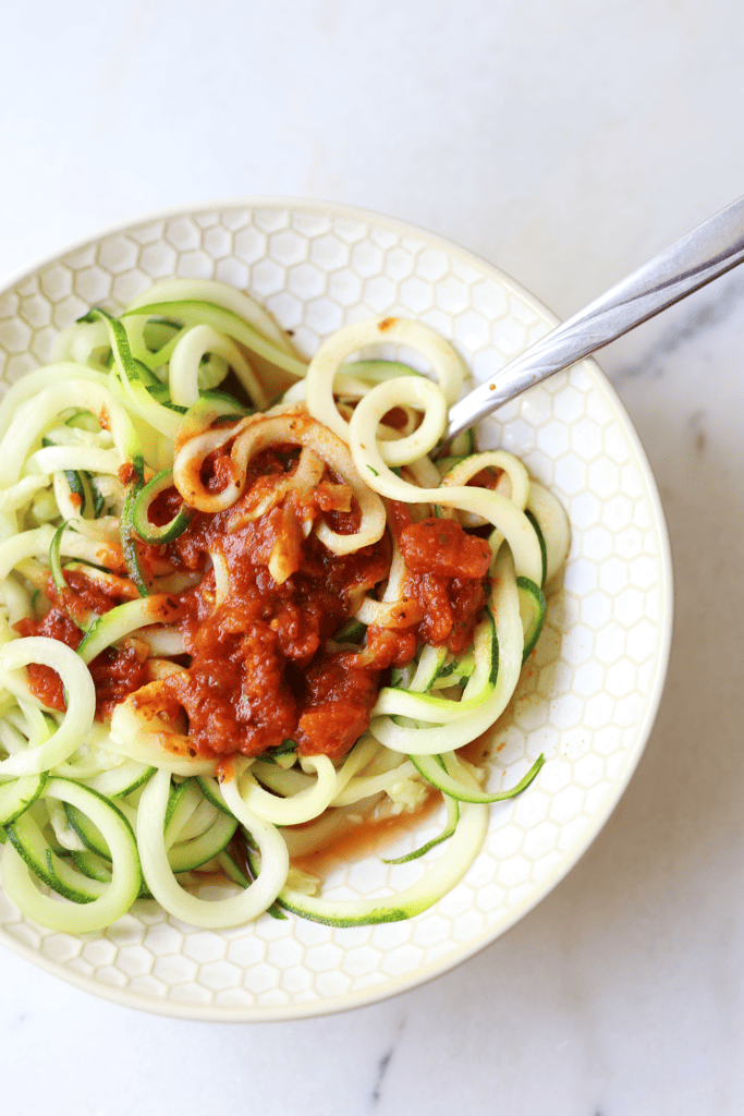 Zucchini noodles in a bowl with marinara sauce