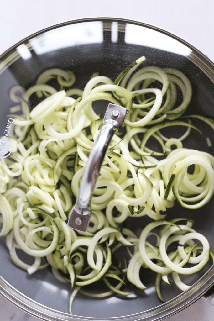 Zucchini noodles in pan ready to steam