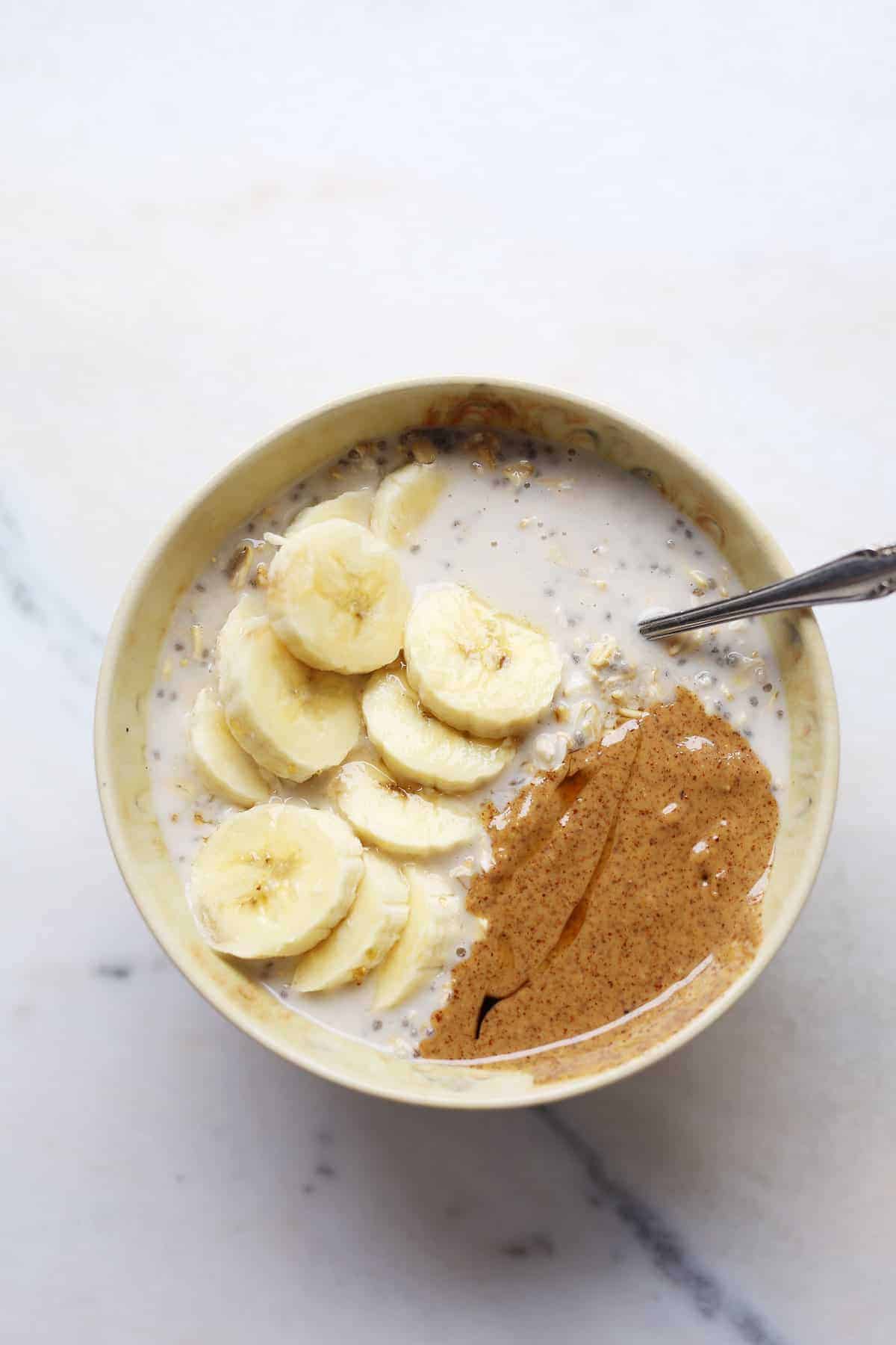 An easy chia bowl on the table topped with bananas and nut butter.