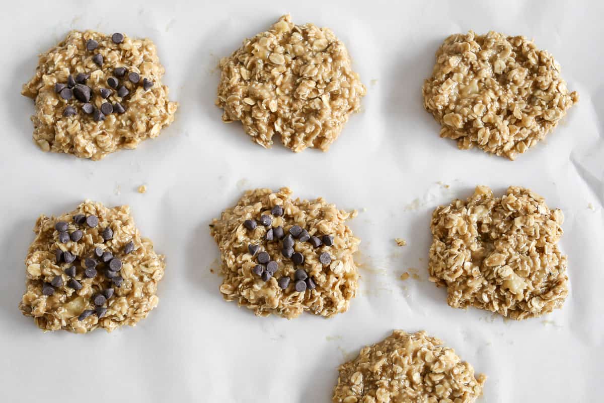 Banana Peanut Butter Oatmeal Cookies shapes and ready to be baked, sitting on a parchment paper lined cookie sheet.