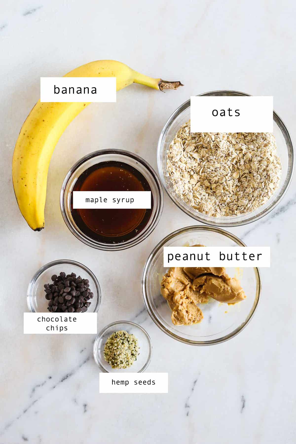 Small glass bowls of ingredients to make Banana Peanut Butter Oatmeal Cookies.