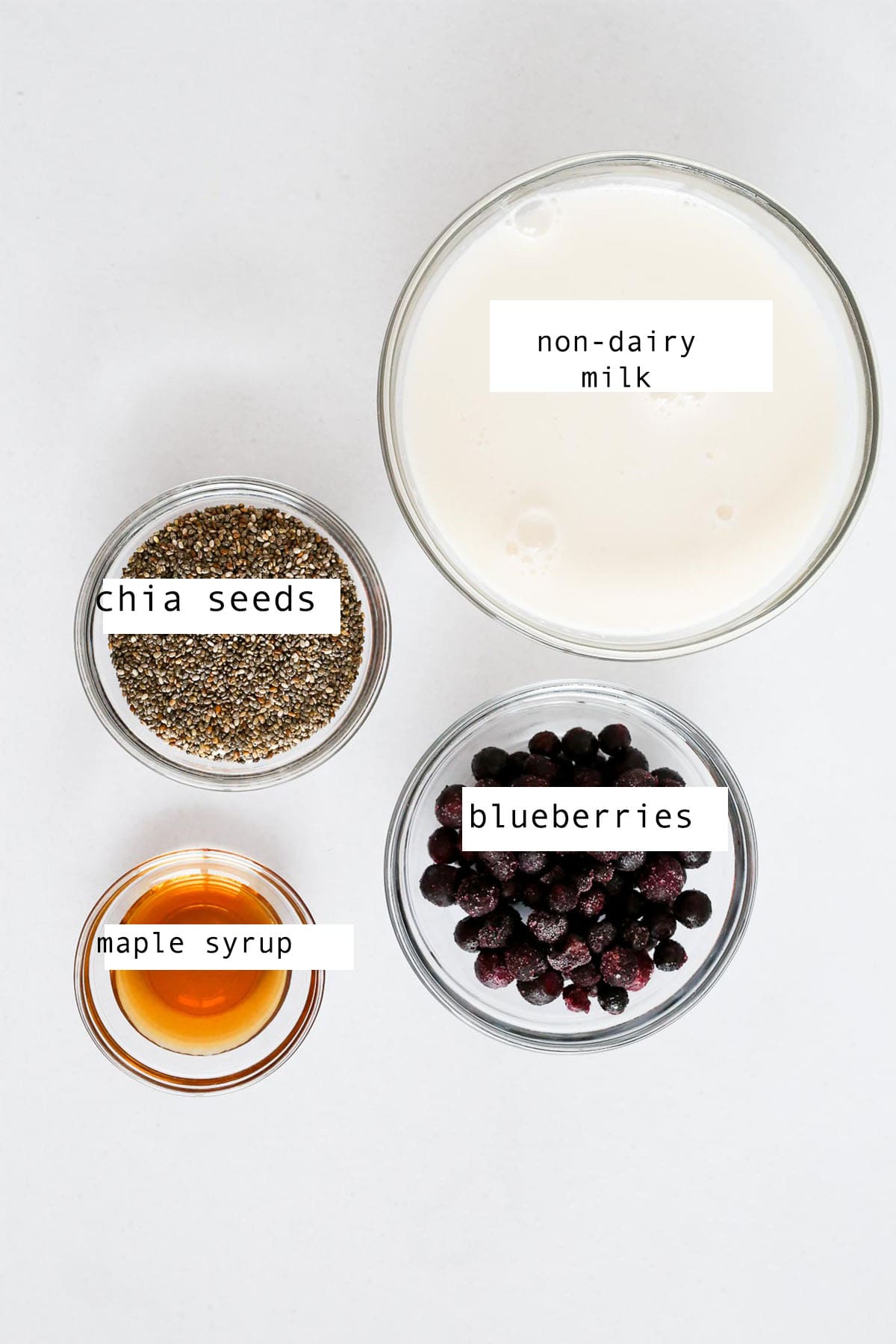 Small glass bowls of ingredients to make Blueberry Chia Pudding.