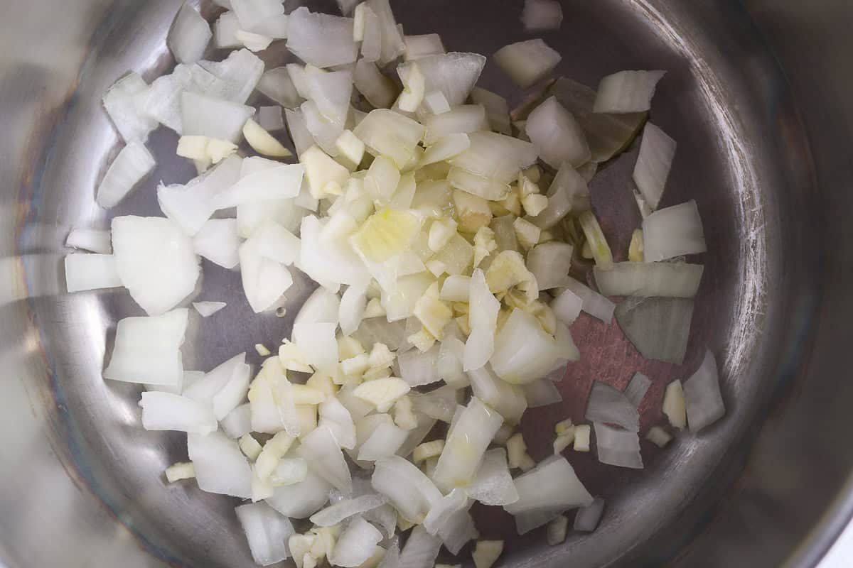 Onion and garlic in pot ready to sautee.