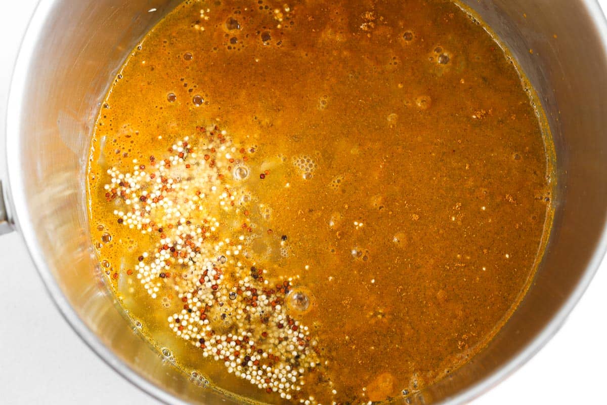 Broth added to pot with quinoa.