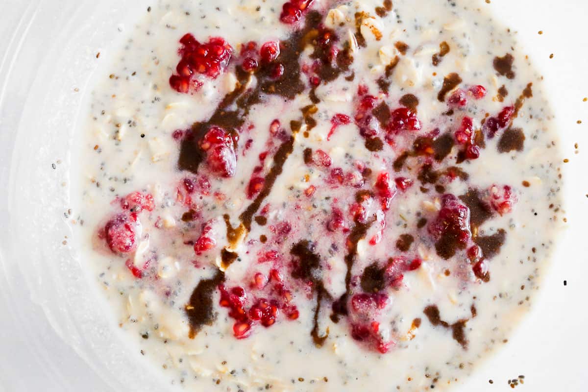 These Raspberry Overnight Oats in a clear glass bowl just after being prepper.