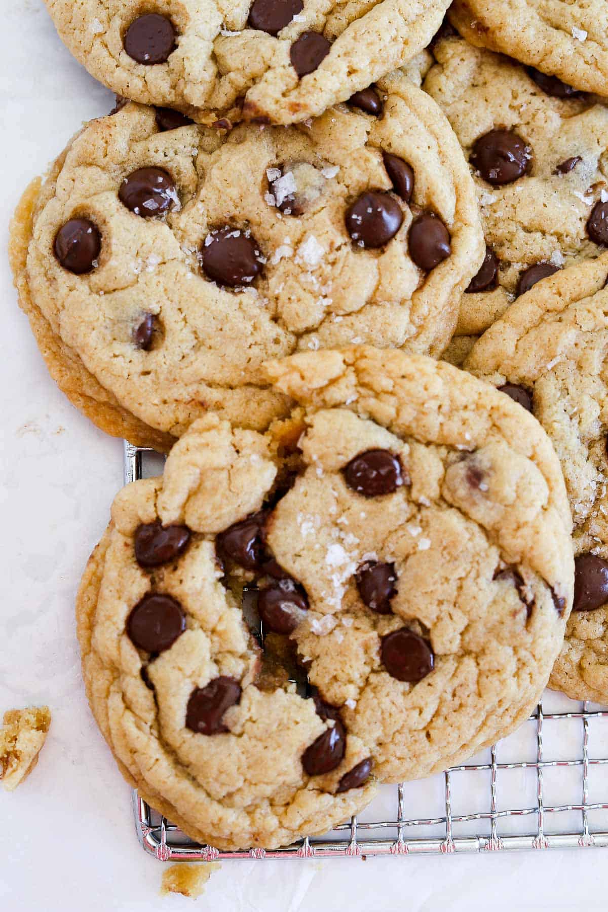 Crispy Chocolate Chip Cookies with one broek in half.