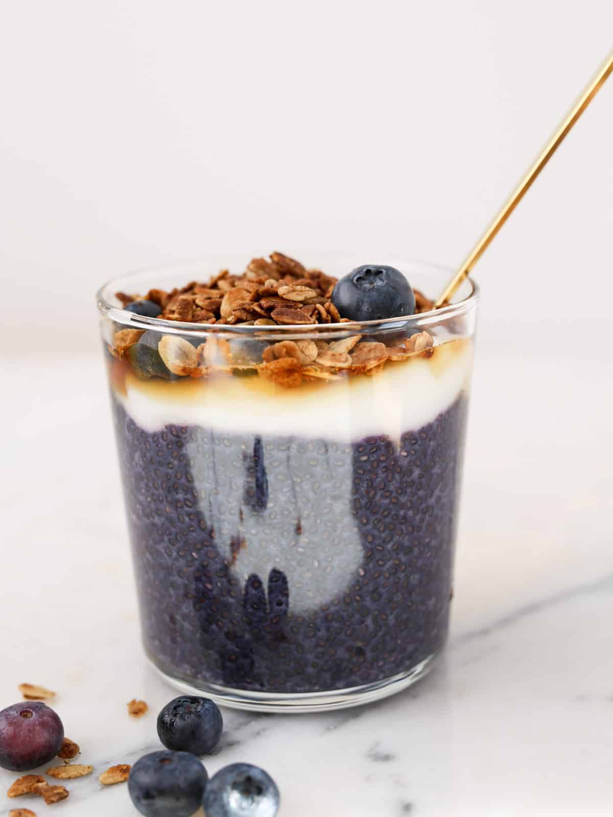 Side image of blueberry chia pudding in a glass cup.