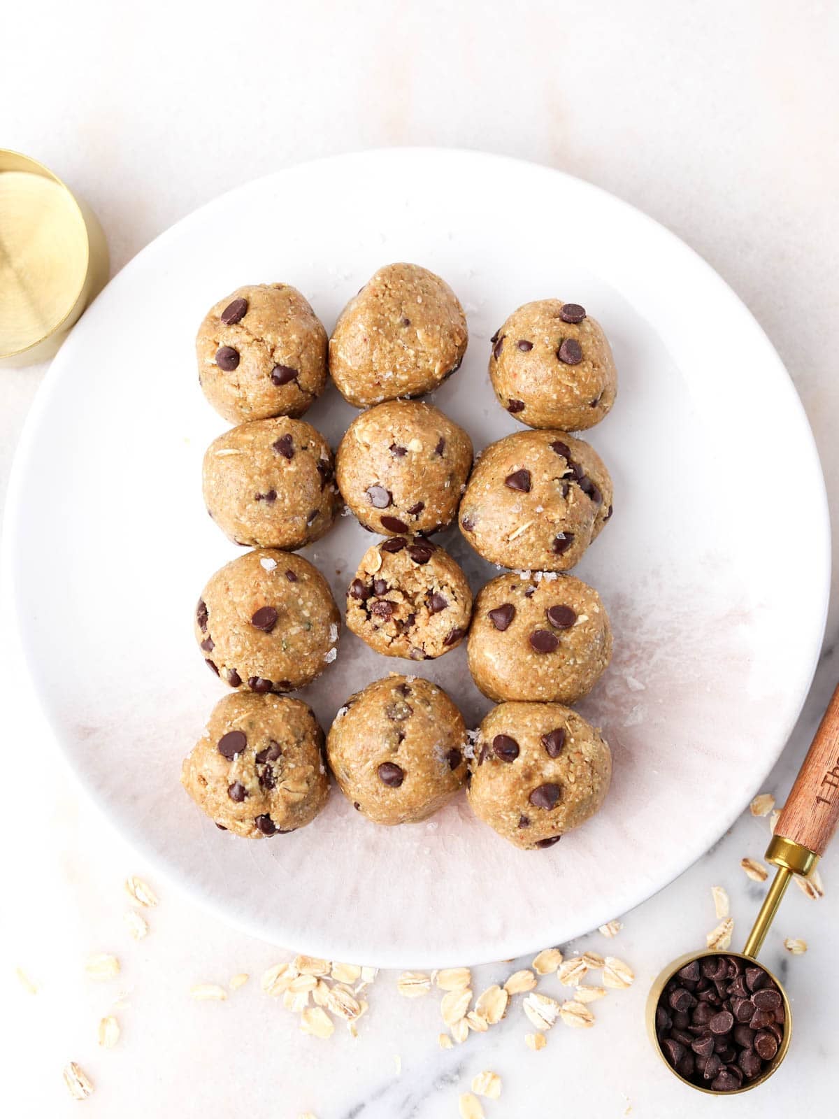 Overhead image of these chocolate peanut butter protein balls on a white plate lined up three across by 4 down.