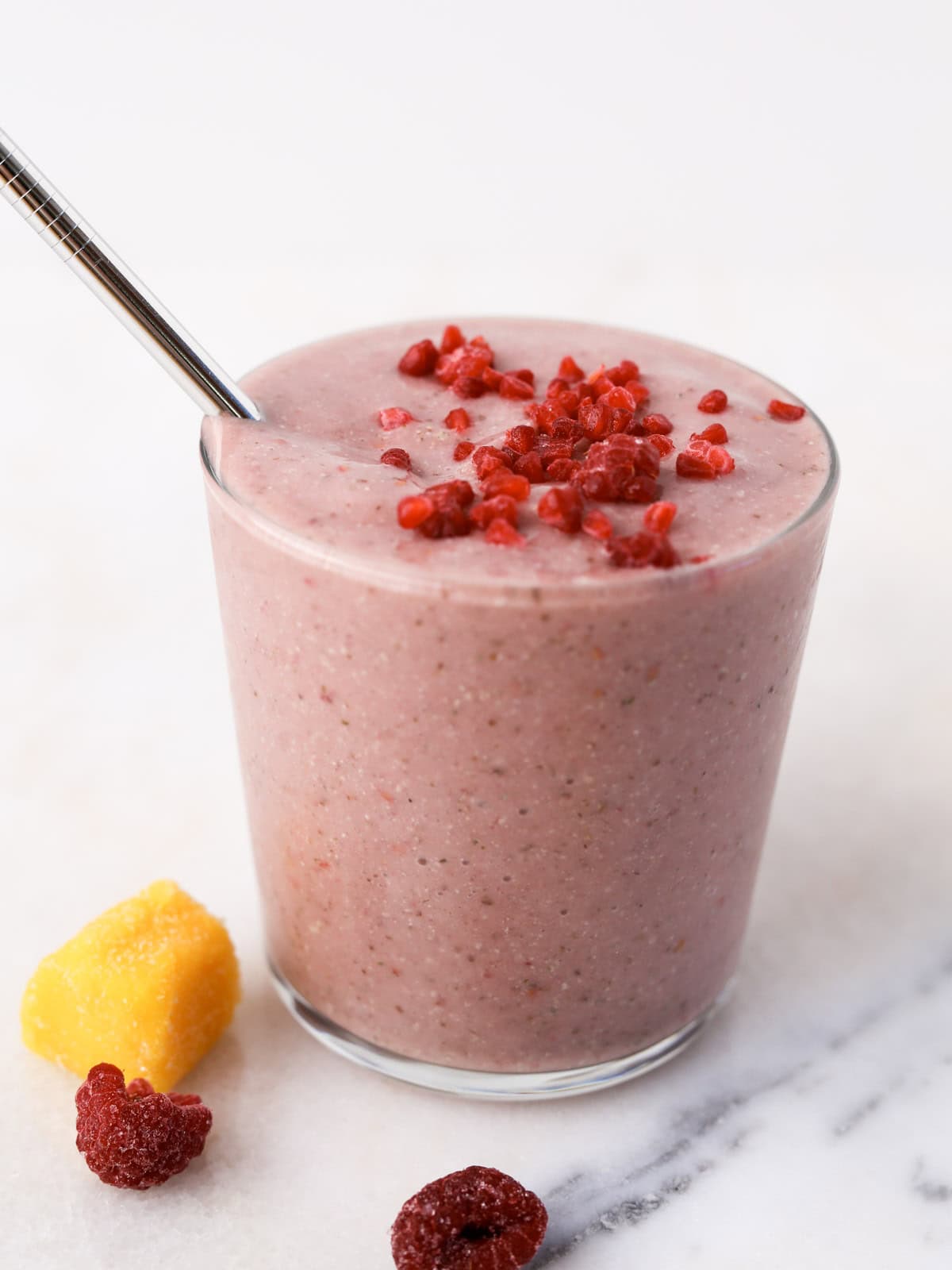 Overhead image of this mango and raspberry smoothie.