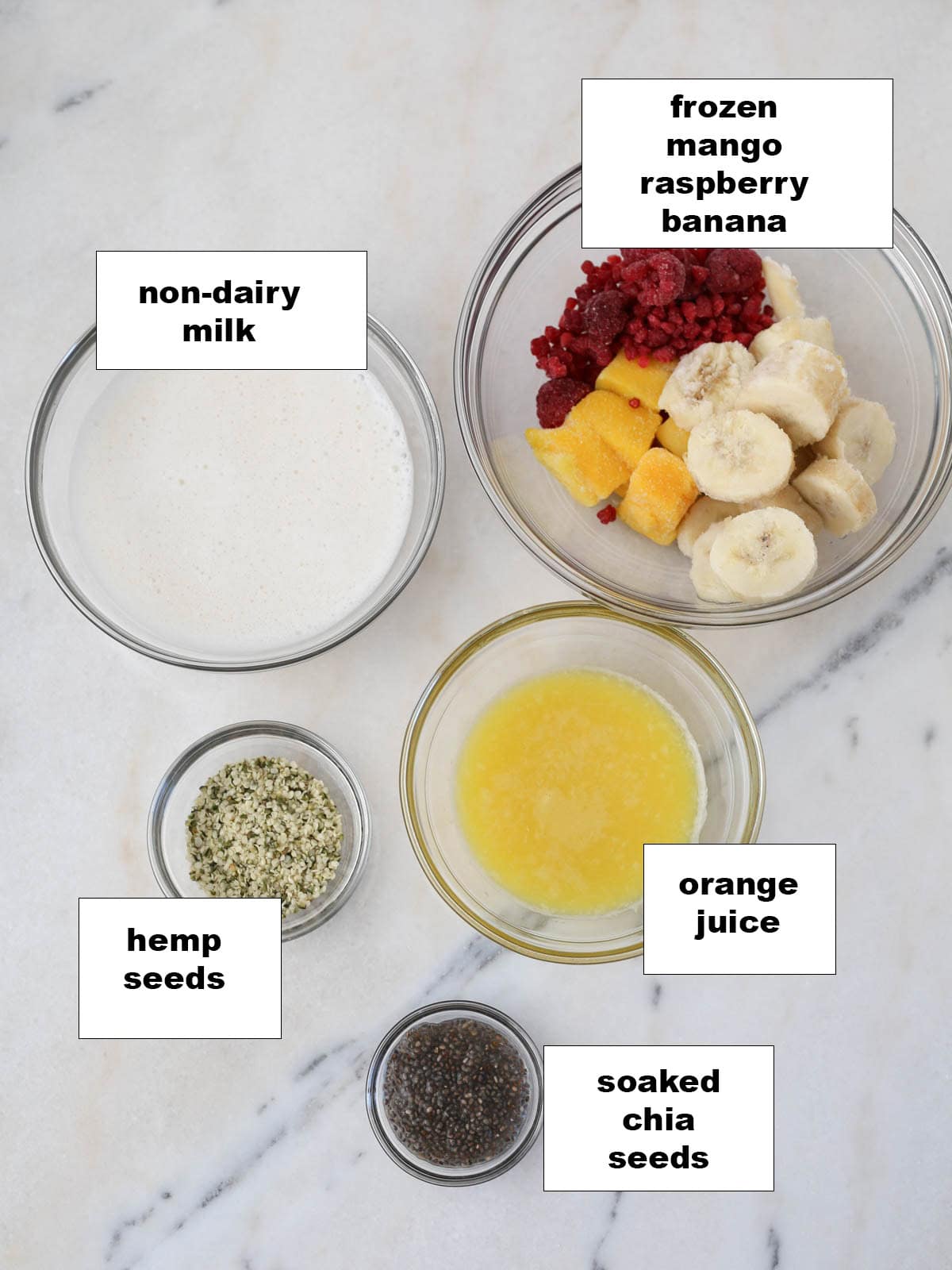 Ingredients on small glass bowls to make this fruity smoothie recipe.