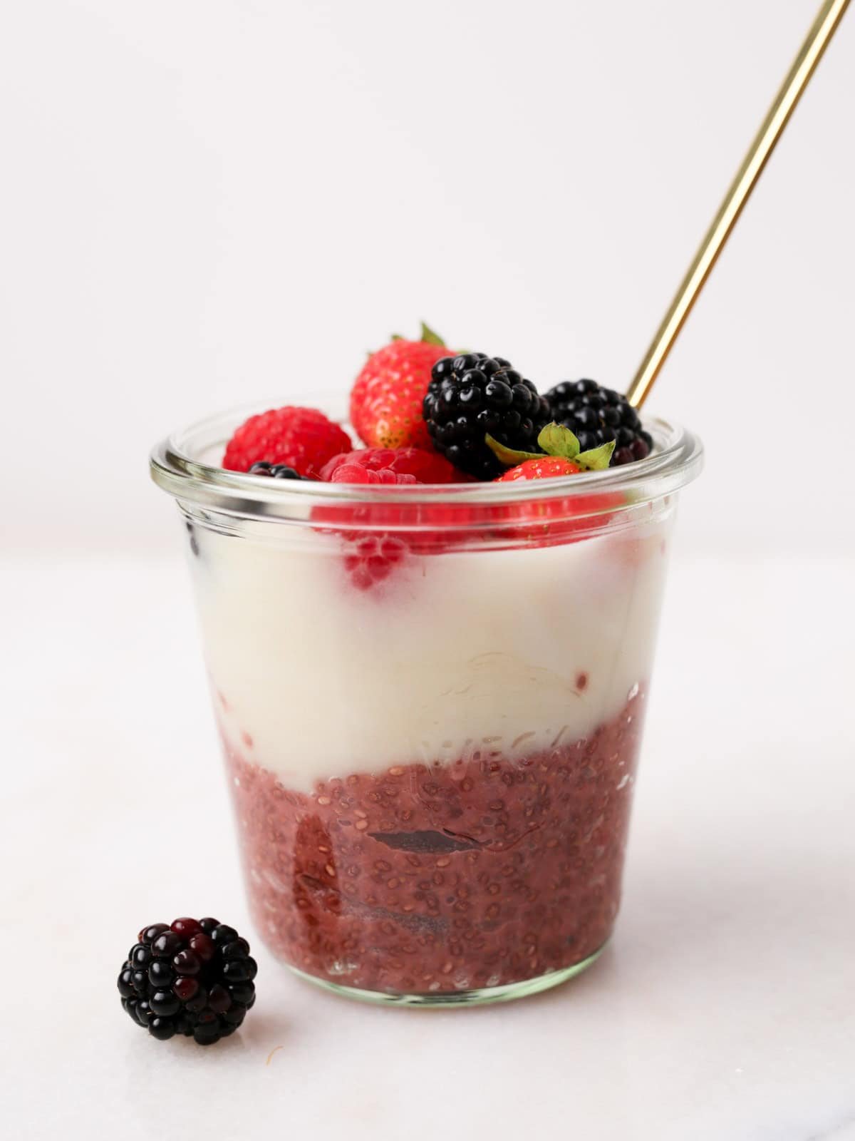 Glass jar with this Parfait without Granola topped with fresh berries.
