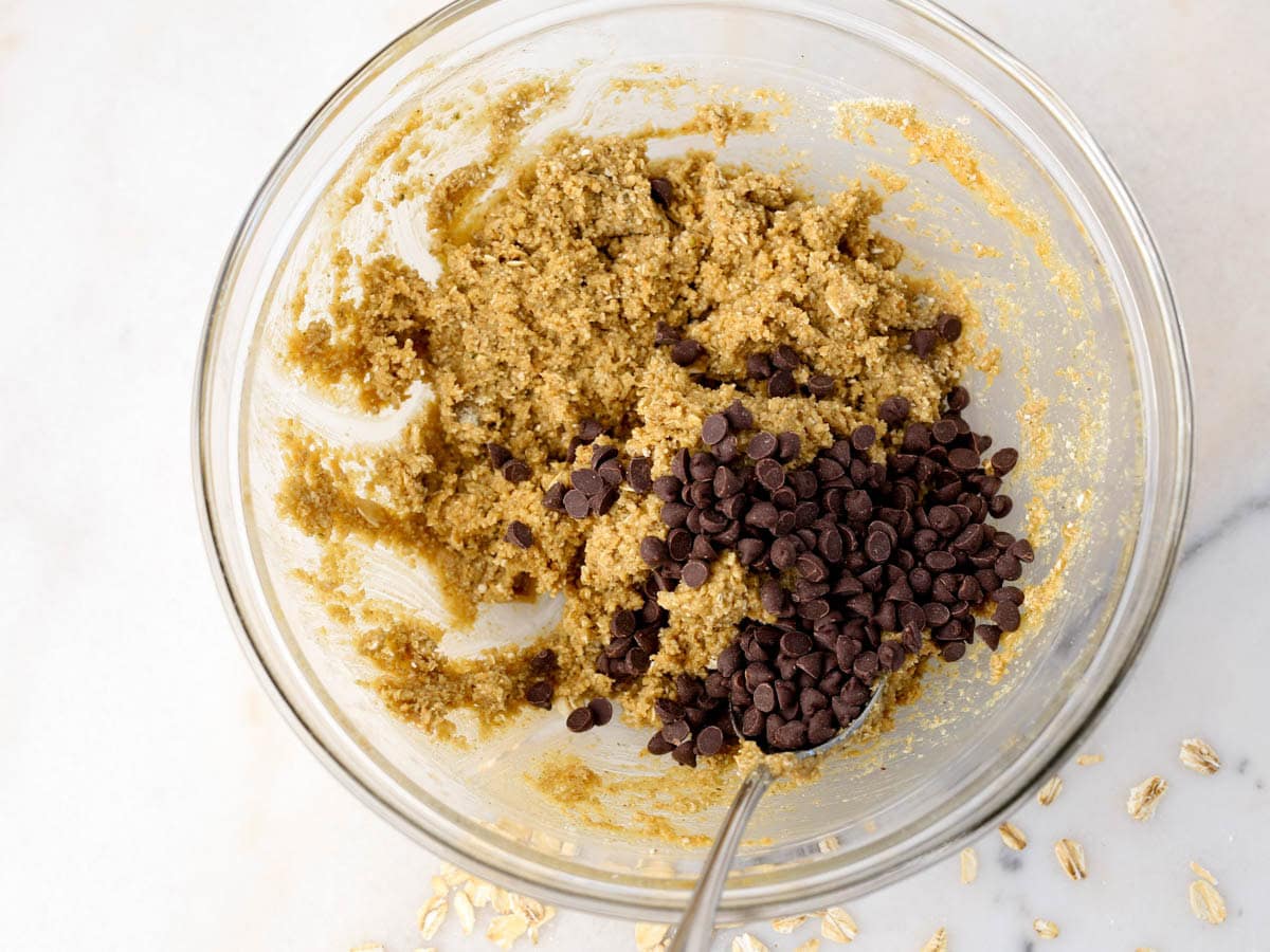 Protein almond butter balls ingredients in glass bowl.