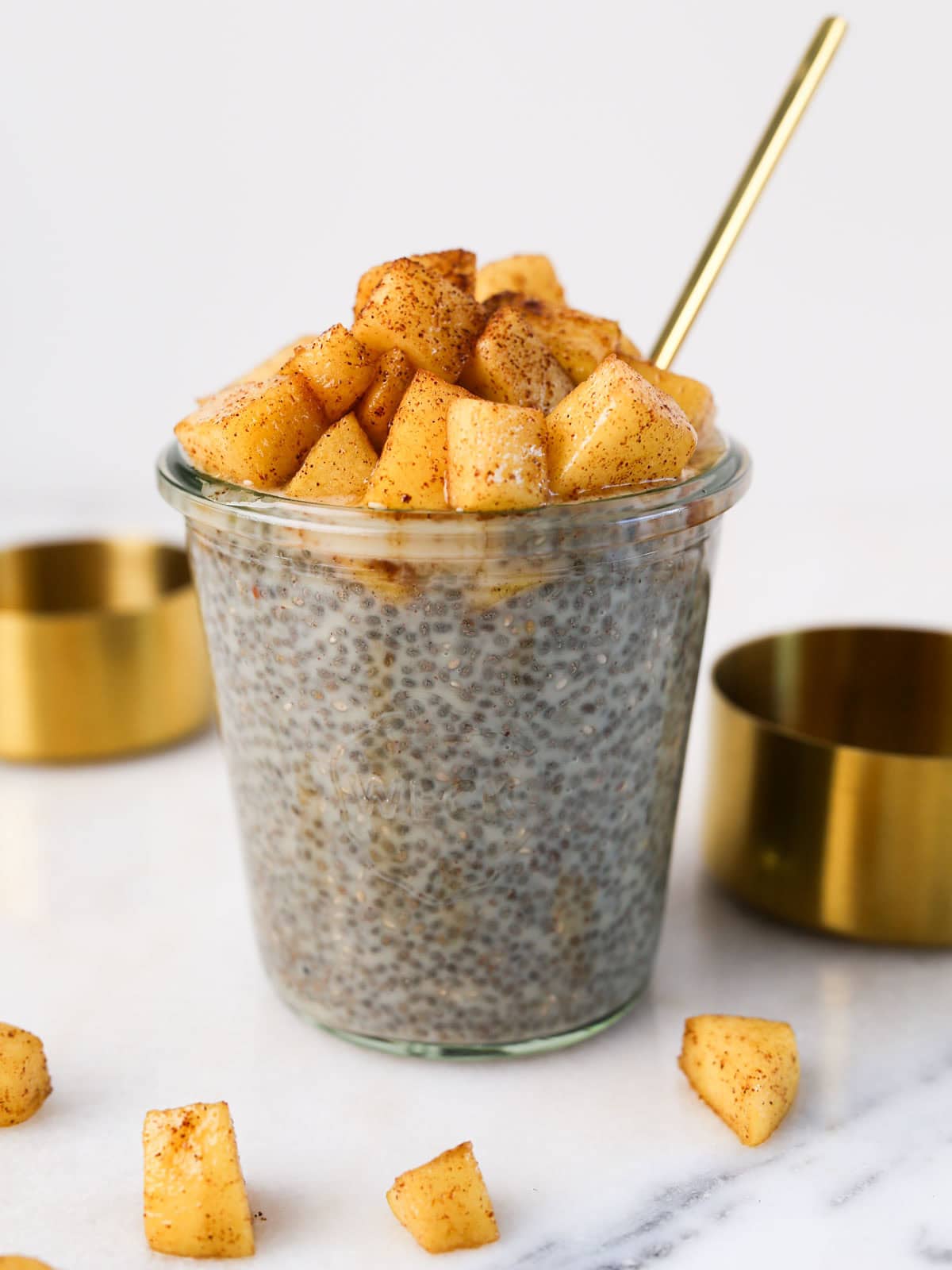 Apple pie chia seed pudding in a glass jar close up image.