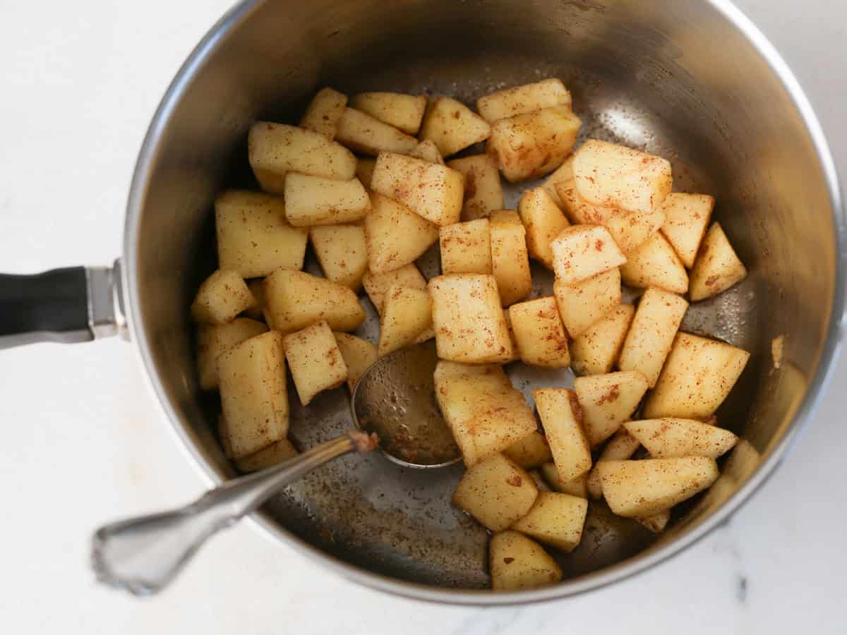 Apples in a pot being cooked to make this apple parfait.
