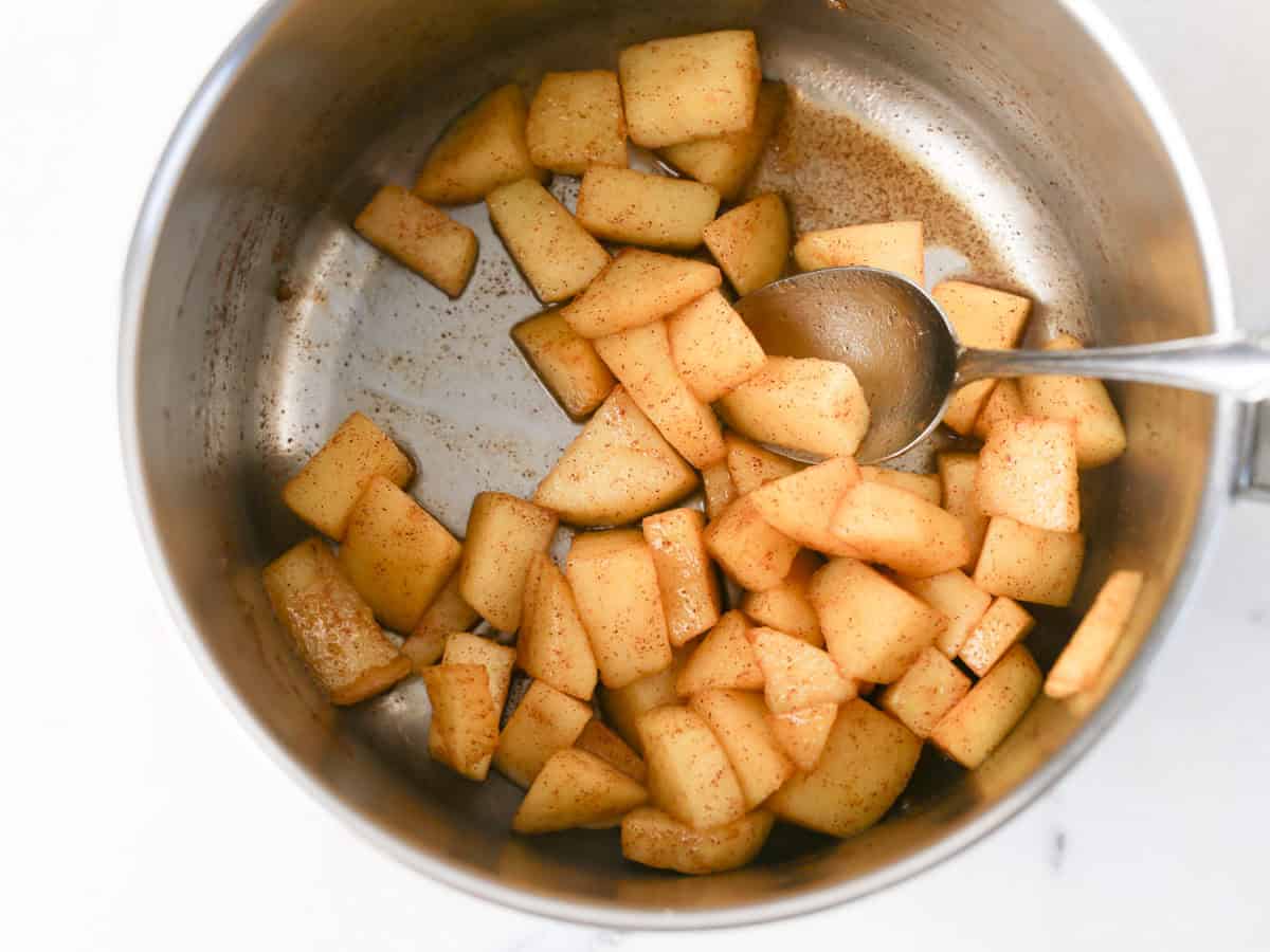 Apples in a pot already cooked to make apple parfaits.