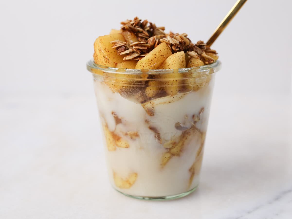 All the layers in a glass jar for this apple cinnamon yogurt parfait.