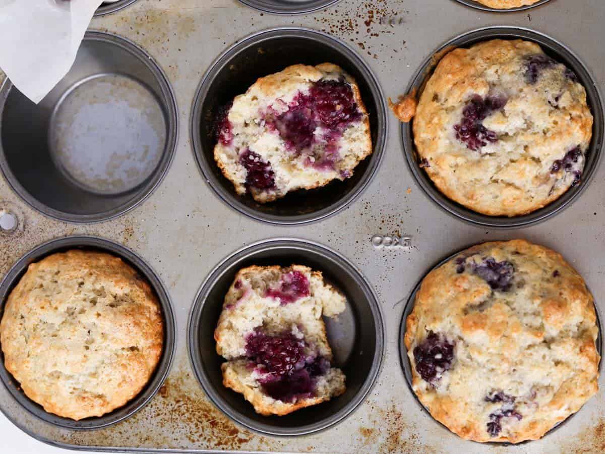 Muffin tin with the baked banana and blackberry muffins.