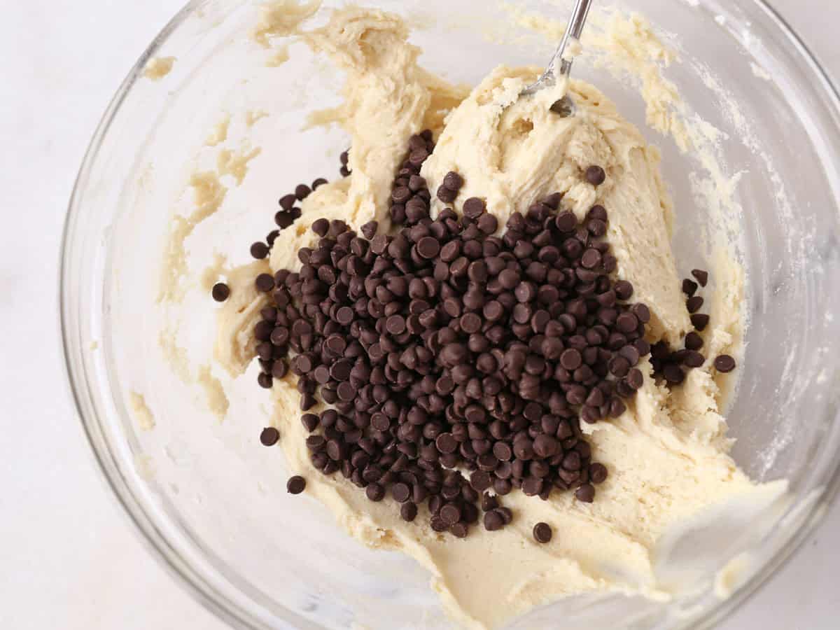 Chocolate chips being folded into the dough.