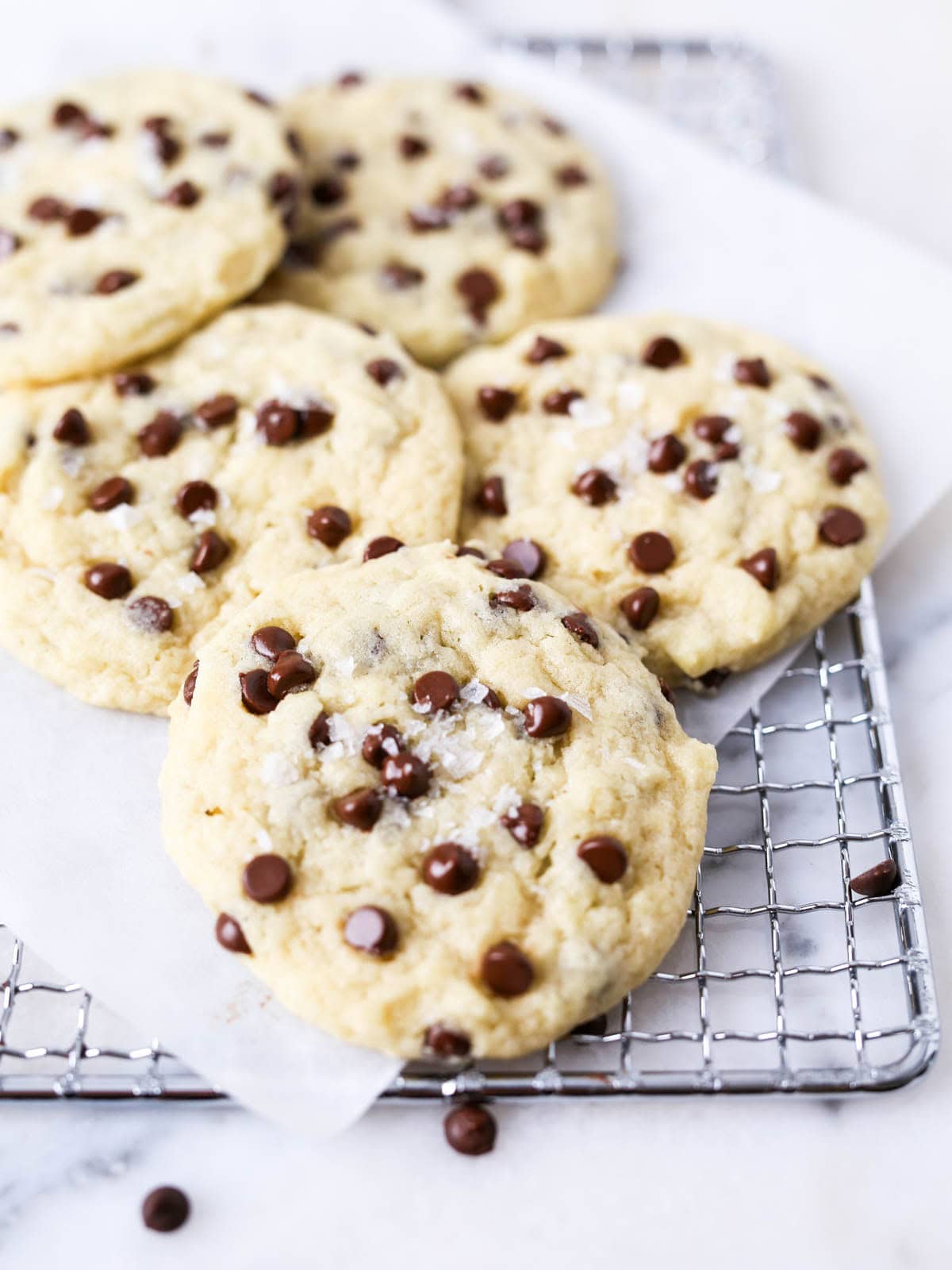 Chocolate chip cookies without brown sugar close up image of multiple laying on top each other.