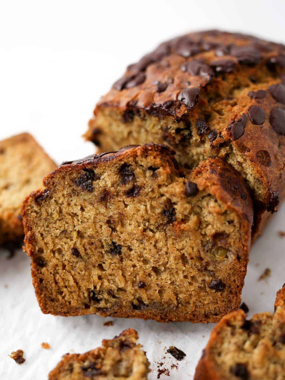 Sliced side view image of this chocolate chunk banana loaf.