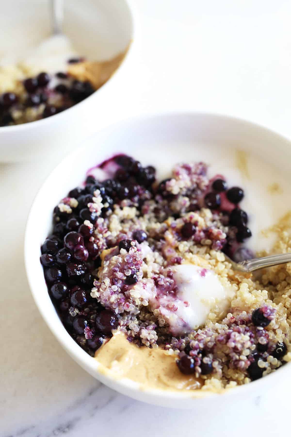 White bowl with this protein breakfast bowl all mixed up.