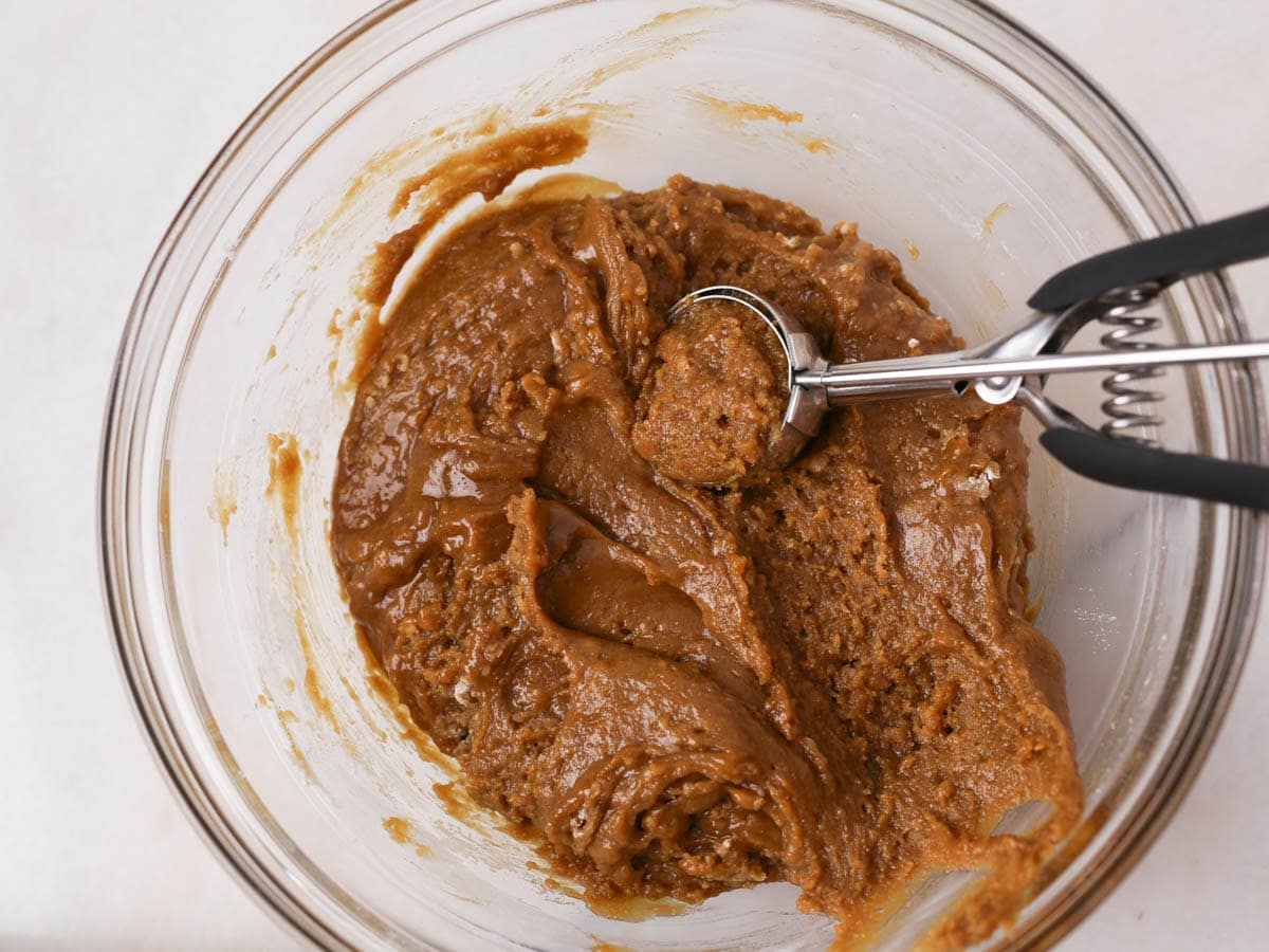 Scooping out cookie dough.