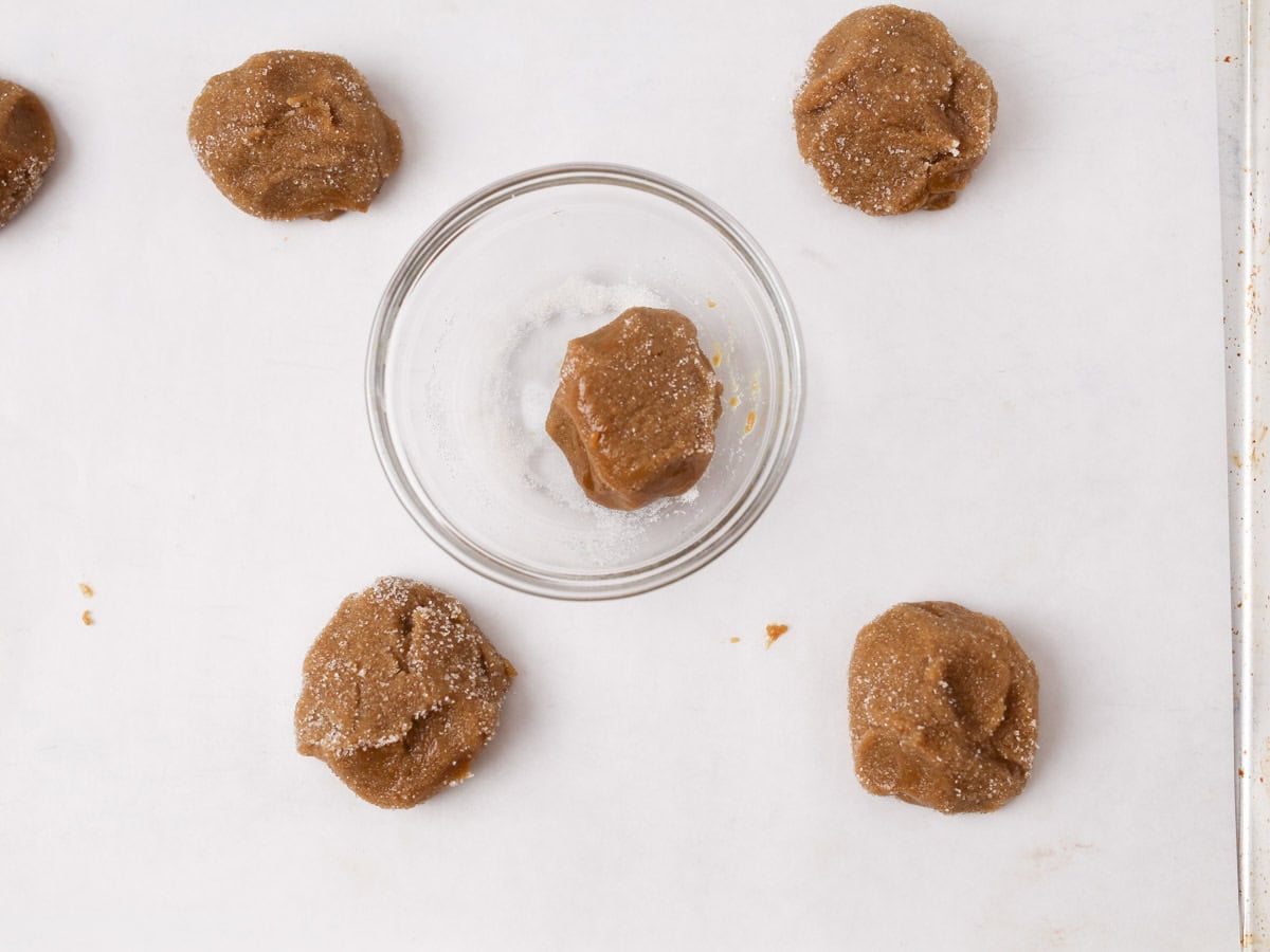 Rolling the vegan ginger cookie dough in sugar.
