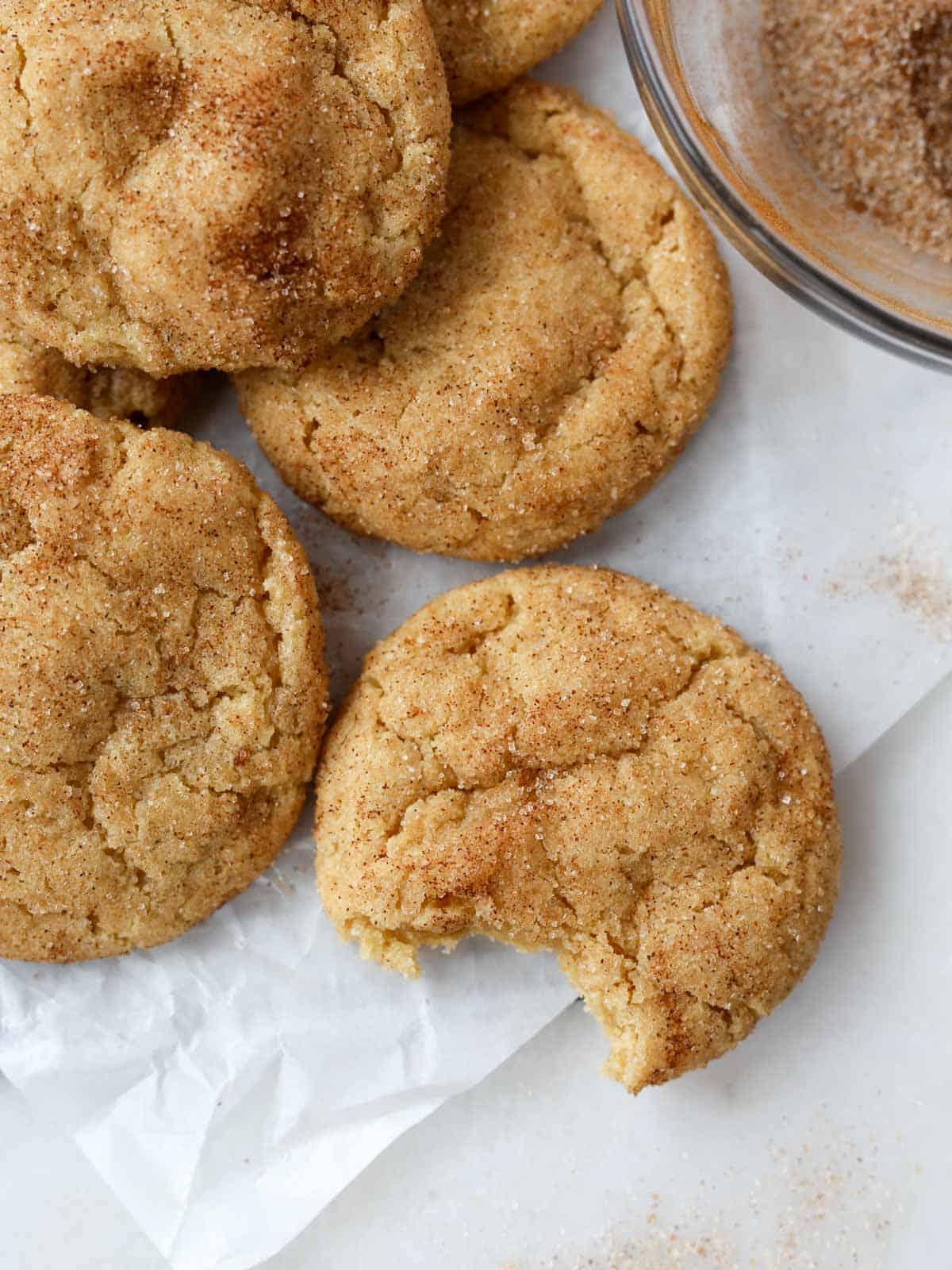 Bite taken out of this vegan snickerdoodle cookie overhead image.